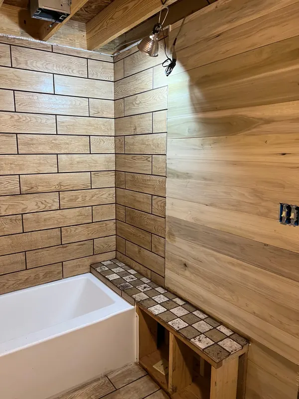 Wood-look tile shower walls and tile bench