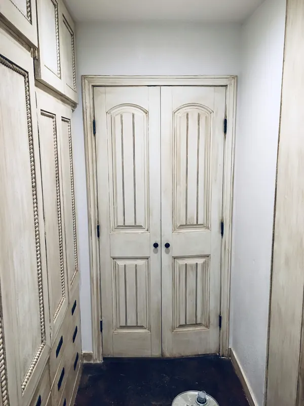 Custom walk-in closet with arched double doors