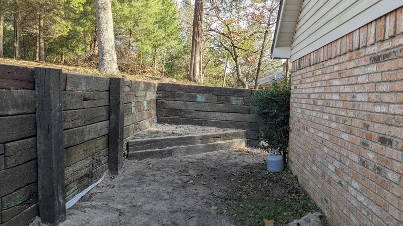Railroad tie retaining wall with built-in steps
